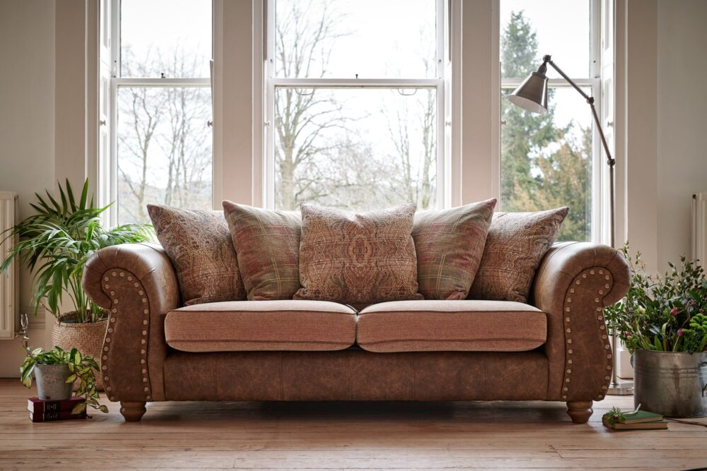 brown leather sofa with pink cushions